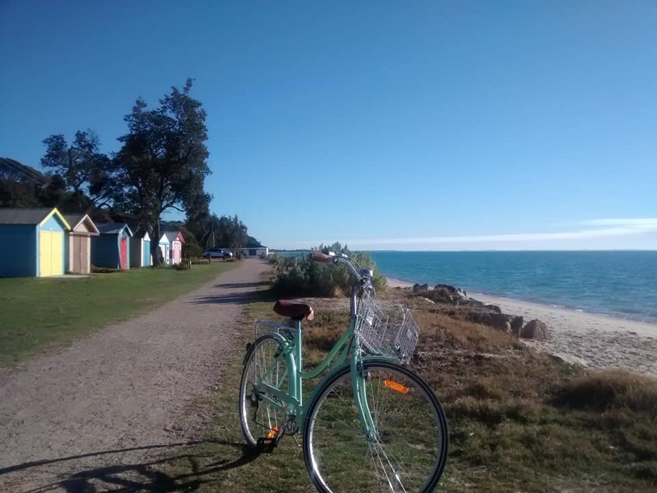 Biking near the bathing boxes at Portsea.