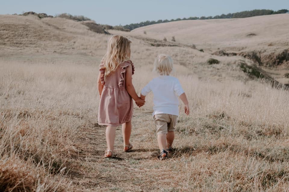 Two grandchildren hand-in-hand.