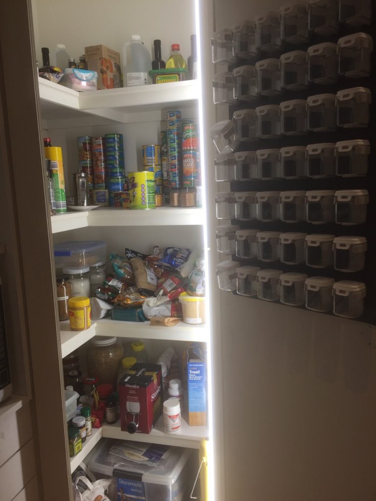 Pantry with HUGE spice rack on the door.