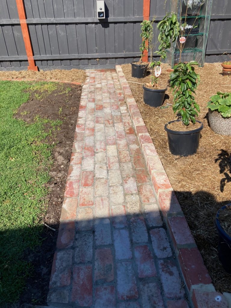 Brick path to the letterbox, next to the 'Orchard.'