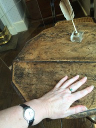 My hand on Jane Austen's writing table.