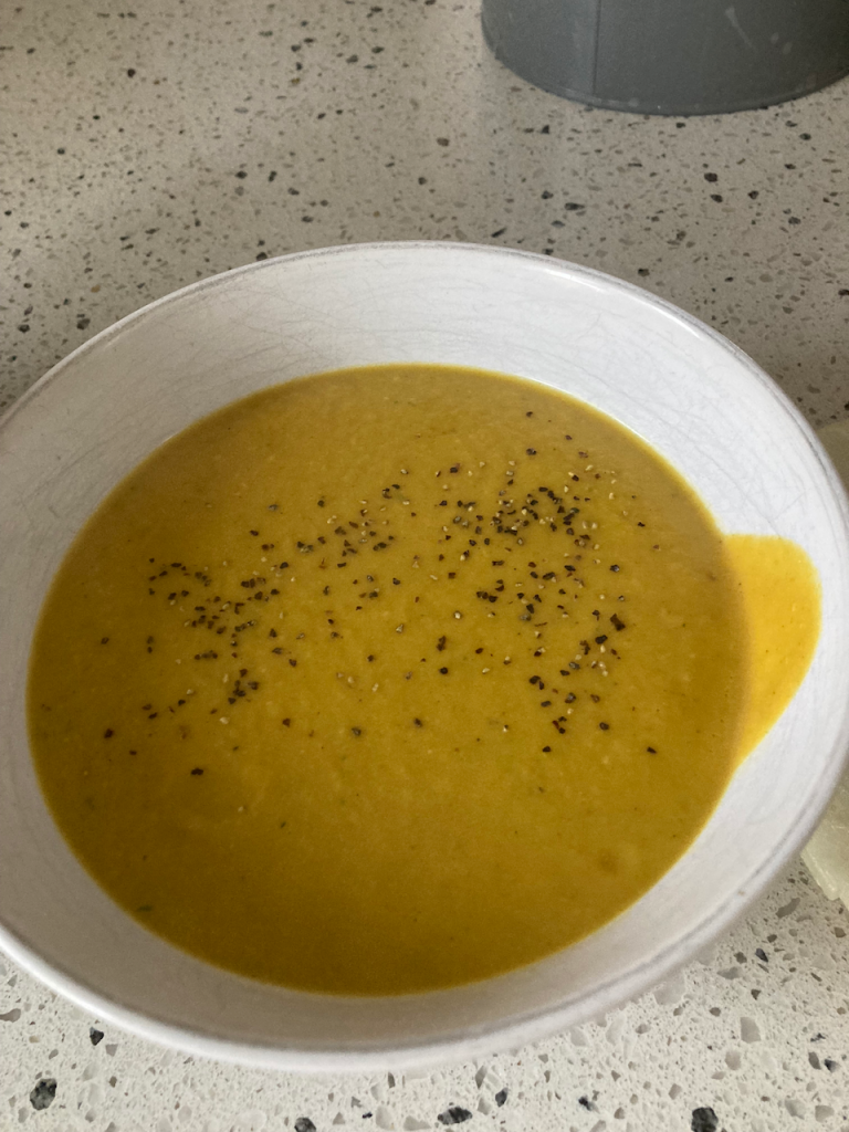 Bowl of pumpkin soup with pepper.