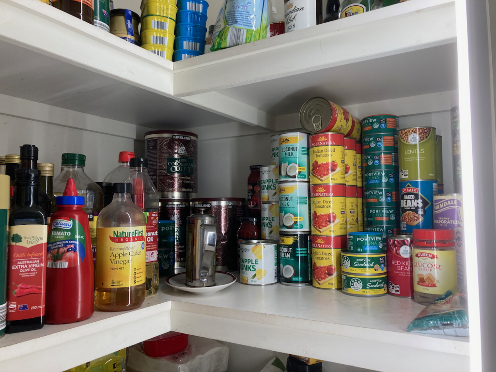 Well-trdered shelf in pantry.