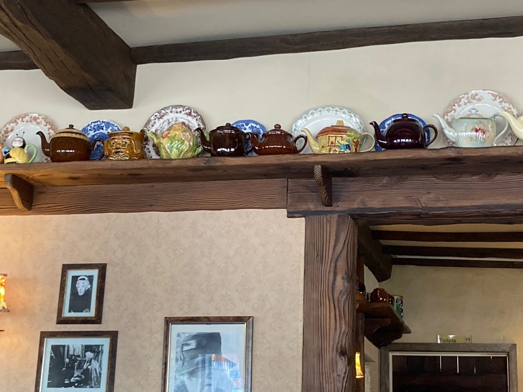 Row of teapots above a doorway.
